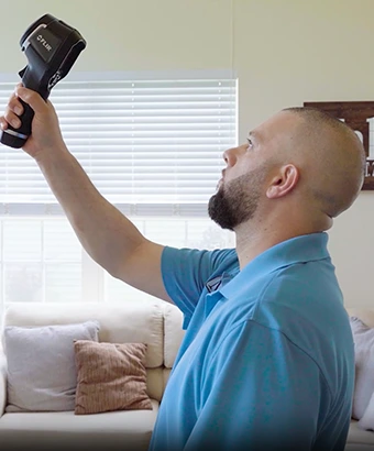 MI&T inspector performing mold inspection with FLIR thermal imaging camera